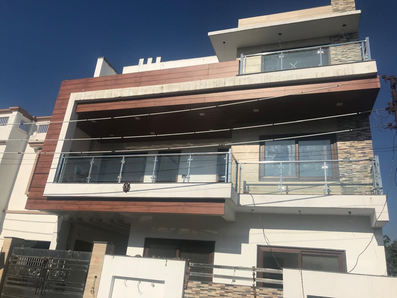 Modern facade with glass balcony railings and wood-look cladding