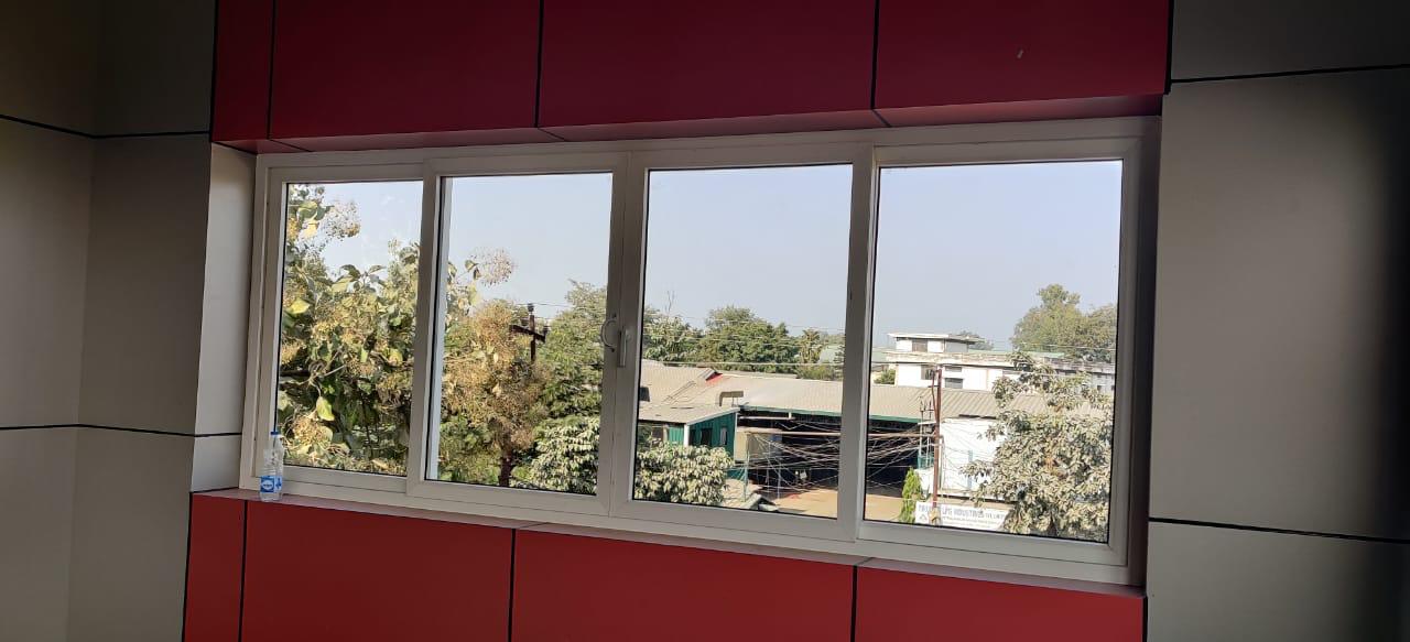 Wide four-panel window installed above a red wall