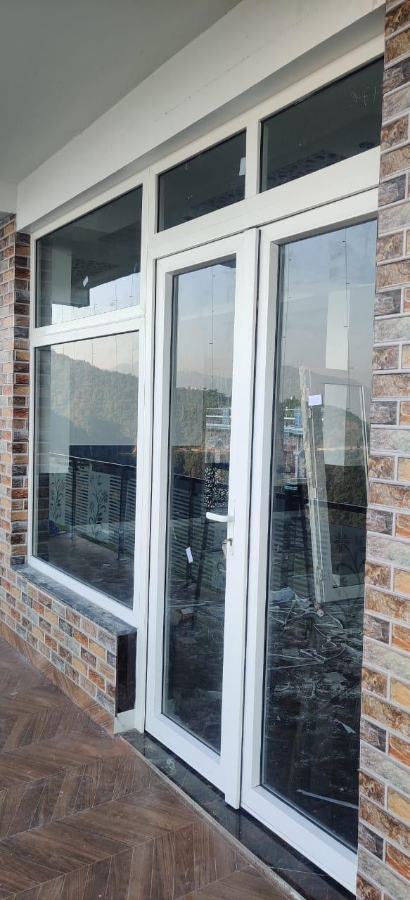 White framed glass door and large windows at a building entrance