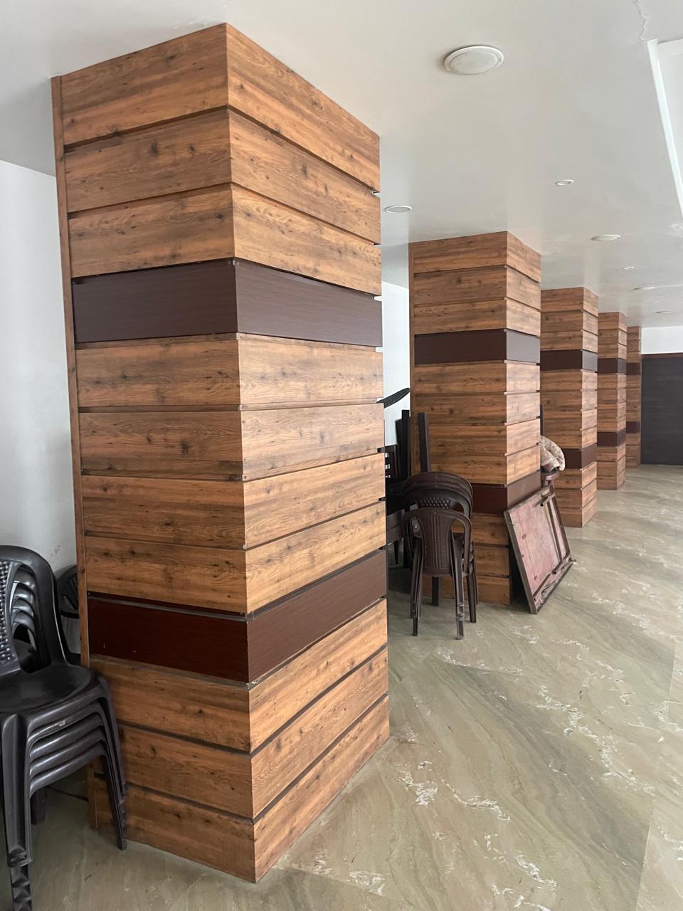 Wood-look cladding on interior columns