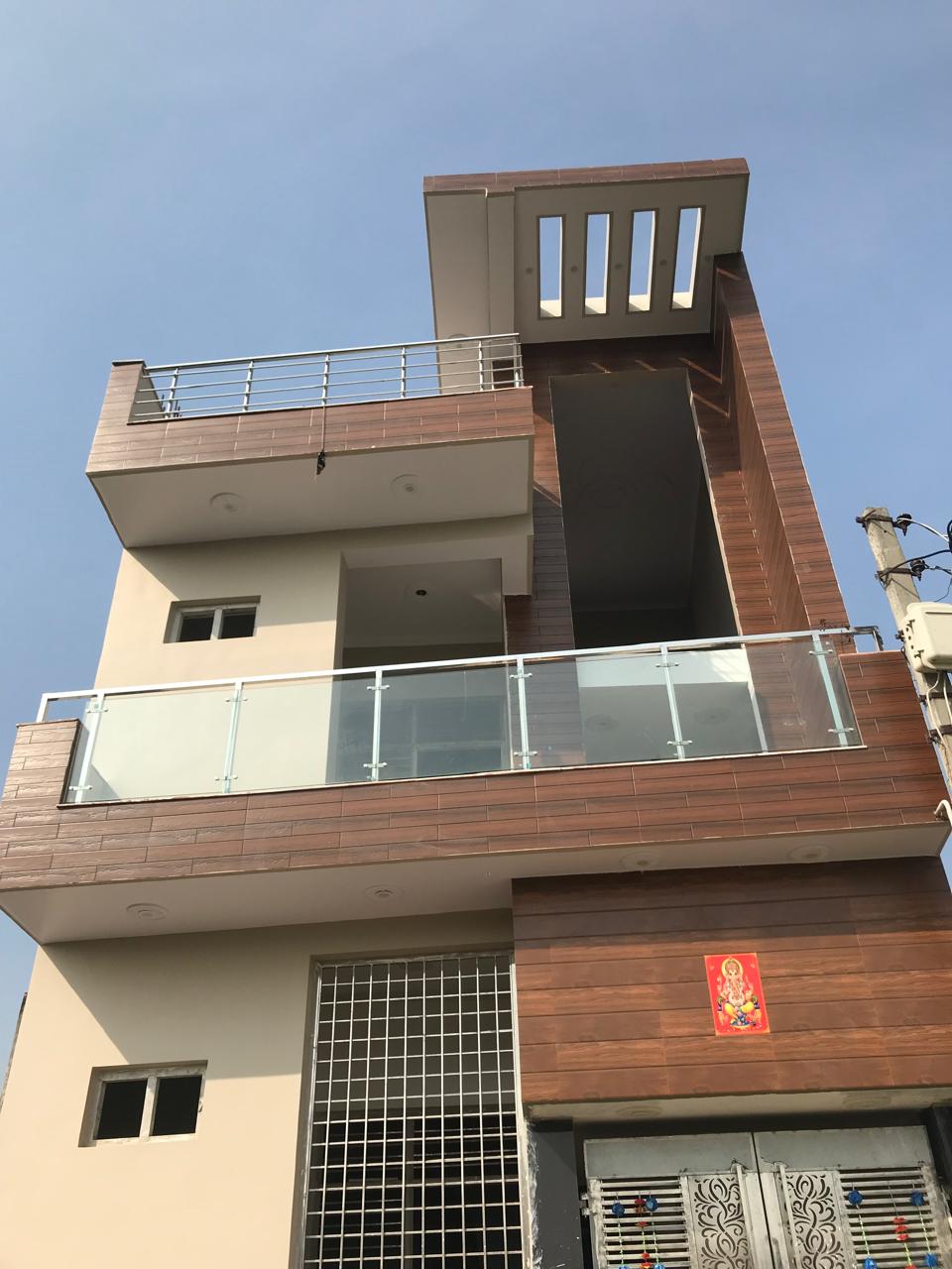 Residential exterior with glass balcony and metal terrace railings